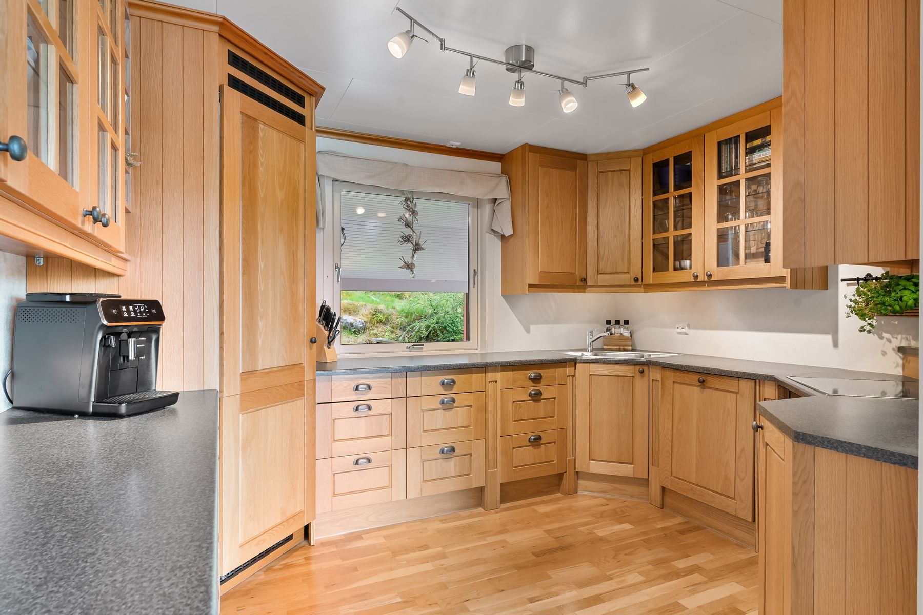 Kitchen with natural wood cabinets and light countertops