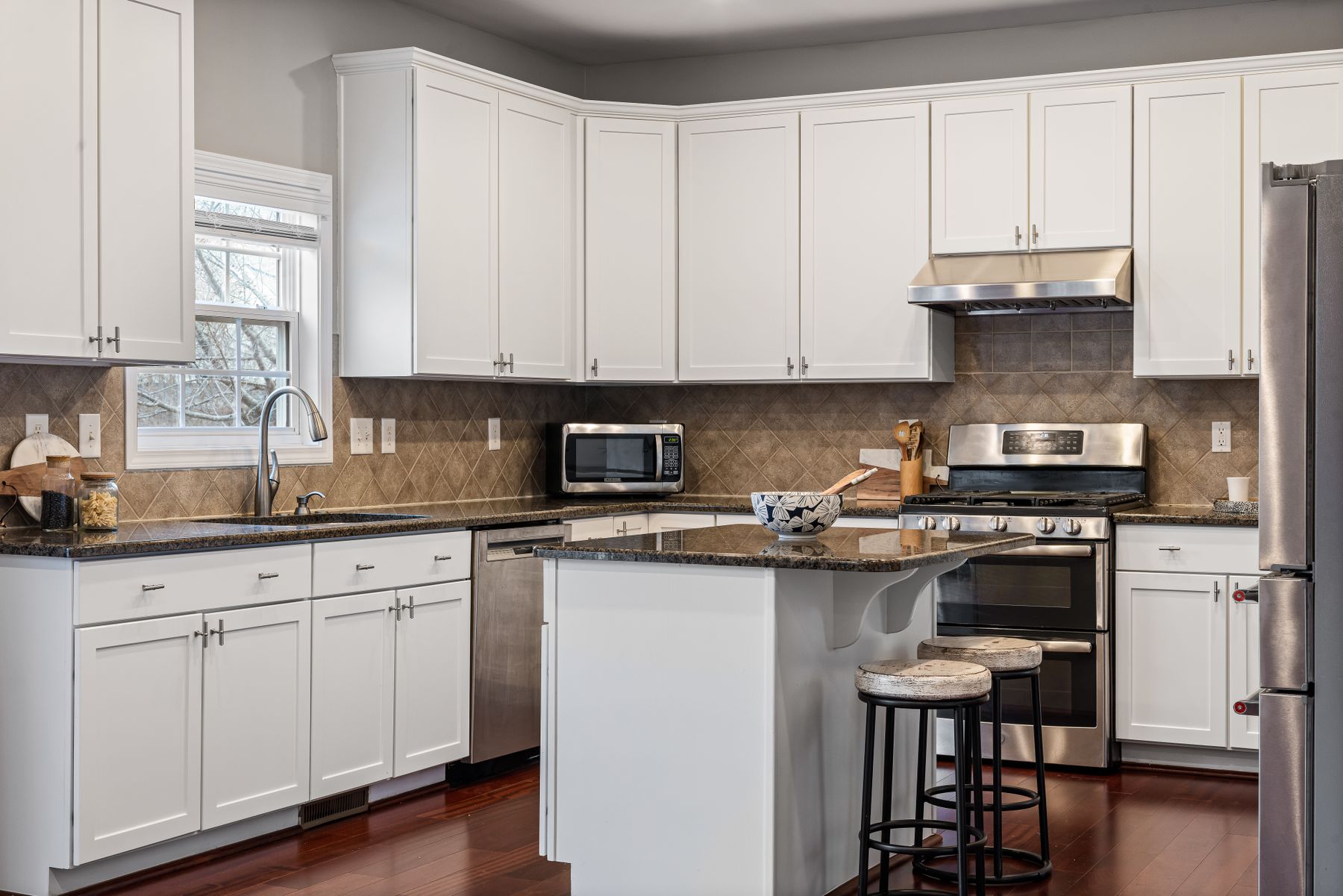 White Shaker-style cabinets in a kitchen with dark countertops
