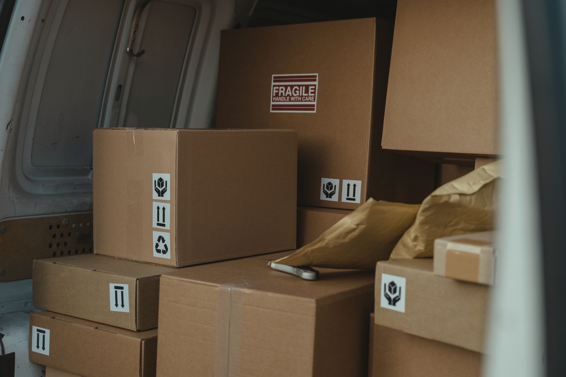 Cardboard cartons stacked in a delivery van
