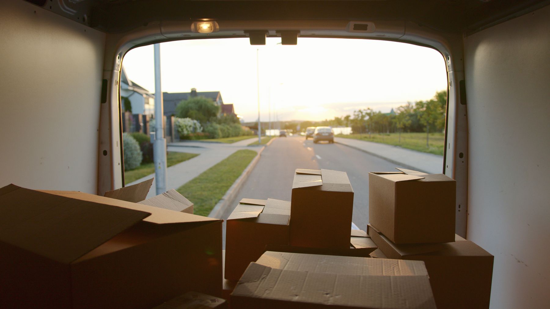 Cardboard boxes in a van overlooking a residential street