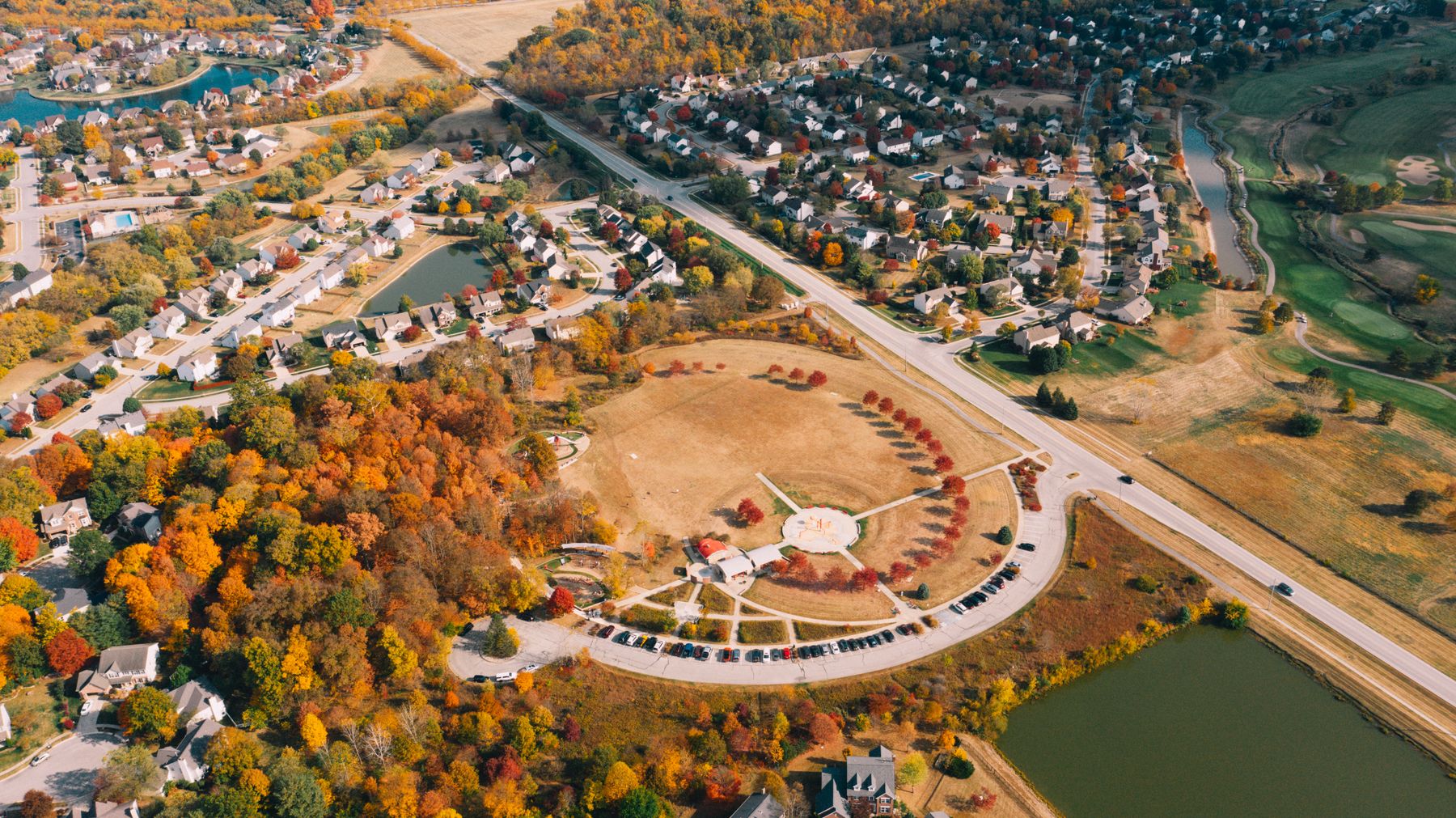 Aerial view of a neighborhood with houses and autumn trees